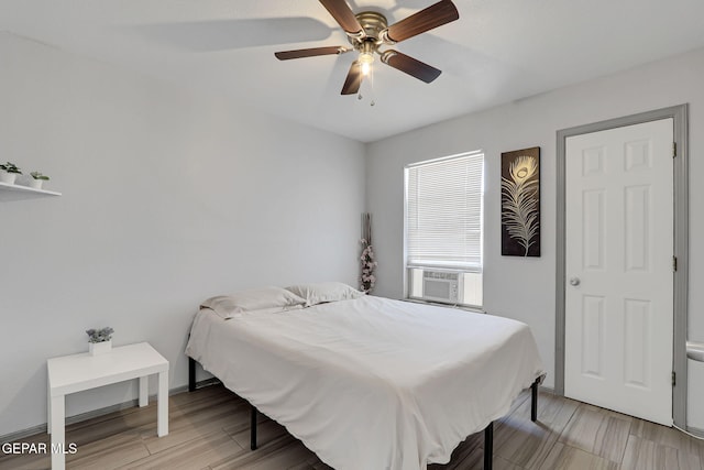 bedroom with ceiling fan and light hardwood / wood-style floors