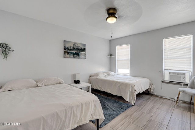 bedroom with cooling unit and ceiling fan