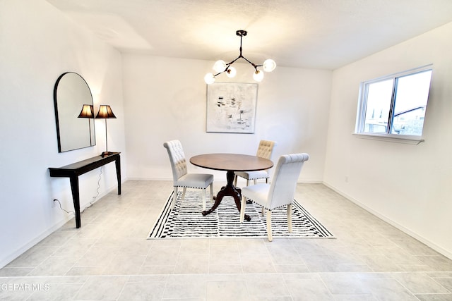 dining space with light tile patterned floors and an inviting chandelier