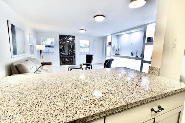 kitchen featuring light stone countertops and a fireplace