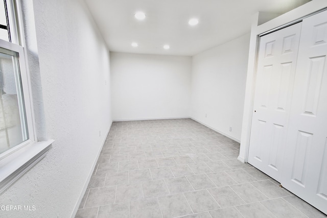 unfurnished room with light tile patterned floors