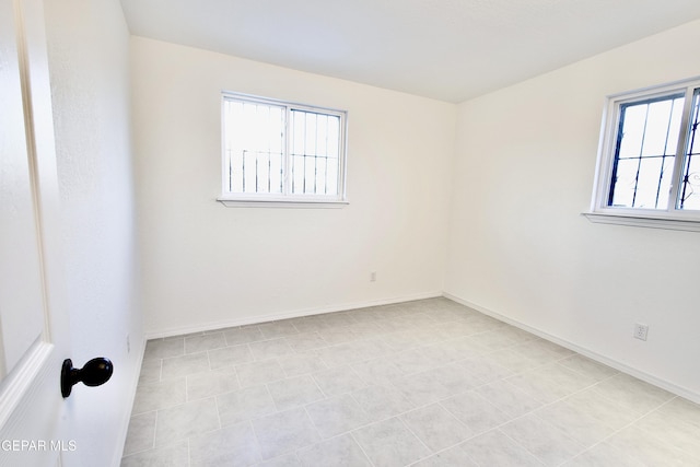 tiled empty room with a wealth of natural light