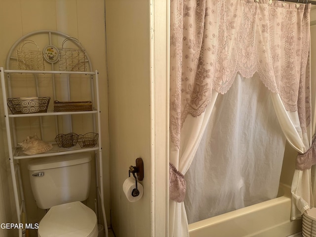 bathroom with toilet and shower / bath combination with curtain