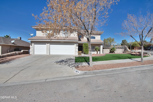 view of front of home with a front yard and a garage