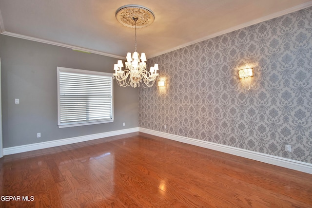 interior space with ornamental molding, a chandelier, and hardwood / wood-style floors