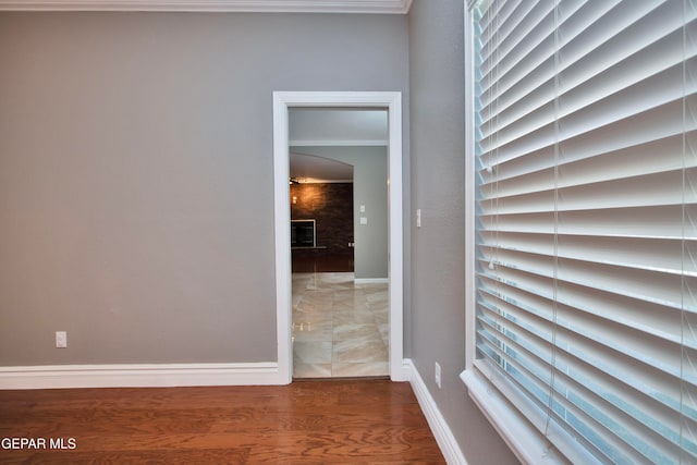 interior space featuring ornamental molding, a fireplace, and wood-type flooring