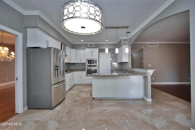 kitchen with kitchen peninsula, crown molding, light stone countertops, white cabinetry, and appliances with stainless steel finishes