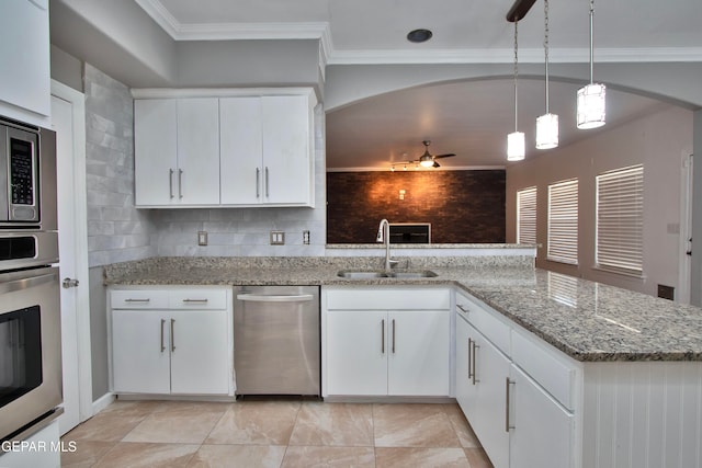 kitchen with kitchen peninsula, white cabinetry, sink, and hanging light fixtures