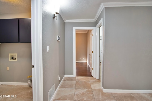 hallway with ornamental molding and a textured ceiling