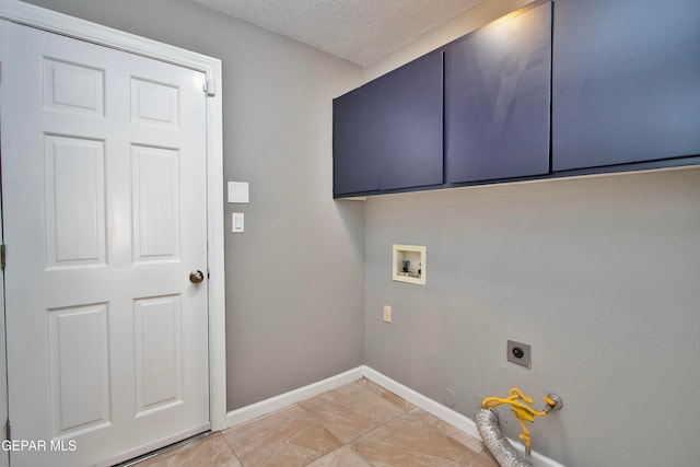 clothes washing area featuring hookup for a gas dryer, electric dryer hookup, washer hookup, cabinets, and a textured ceiling