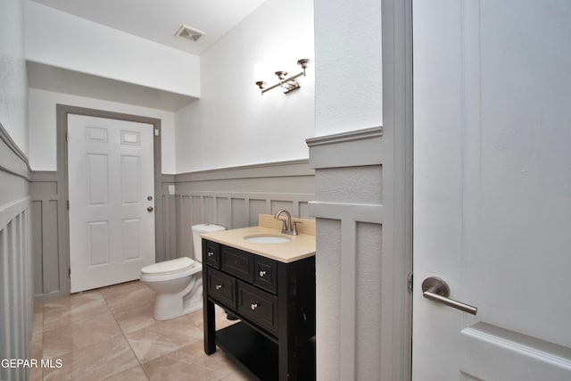 bathroom featuring vanity, toilet, and tile patterned floors