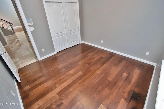 unfurnished bedroom with a closet and wood-type flooring