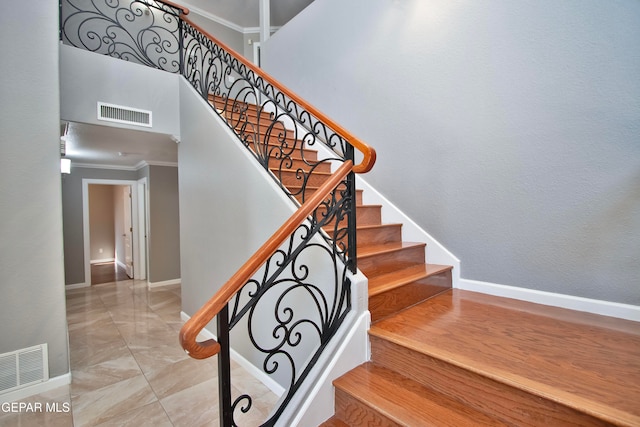 staircase featuring crown molding