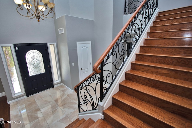 foyer with a chandelier and a high ceiling