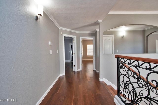 hallway with dark wood-type flooring and crown molding