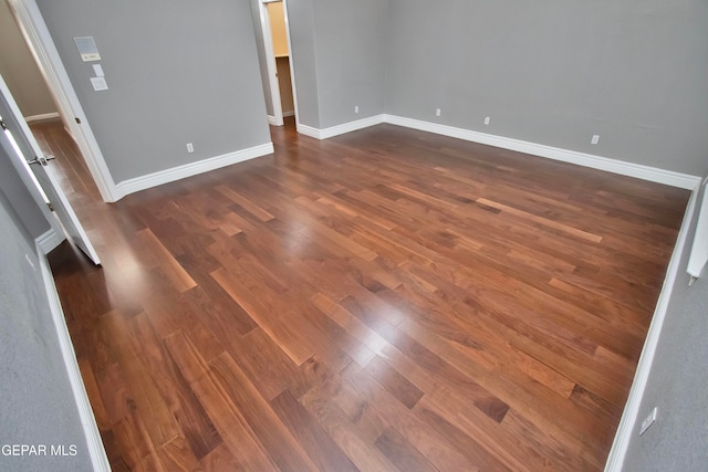 spare room featuring dark wood-type flooring