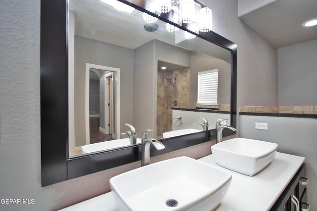 bathroom featuring vanity and a tile shower