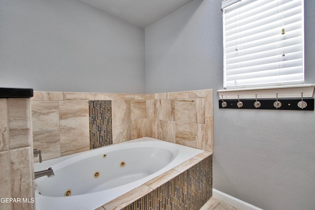 bathroom featuring tiled tub