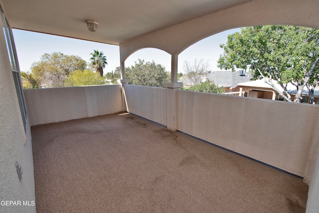 view of patio featuring a balcony