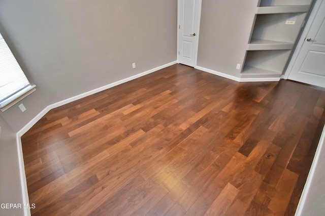 unfurnished bedroom featuring dark wood-type flooring