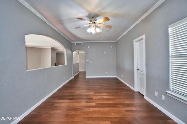 unfurnished room featuring crown molding, dark wood-type flooring, and ceiling fan