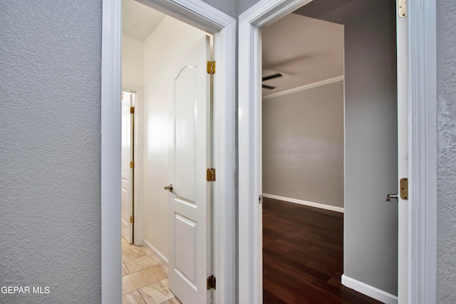 corridor featuring ornamental molding and hardwood / wood-style floors