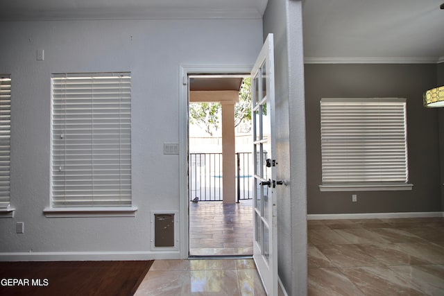 entryway with french doors, crown molding, and light hardwood / wood-style flooring