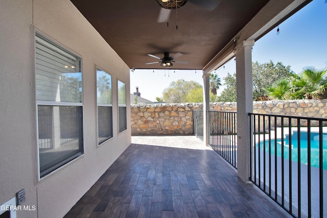 view of patio featuring a fenced in pool and ceiling fan