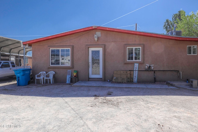 rear view of house with a carport