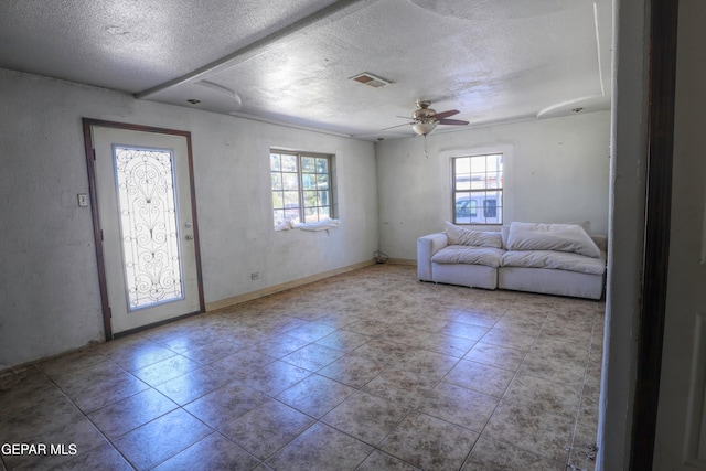 foyer featuring light tile patterned flooring, a textured ceiling, and ceiling fan