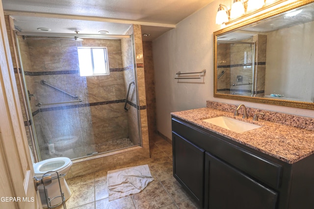 bathroom featuring vanity, toilet, tile patterned floors, and walk in shower