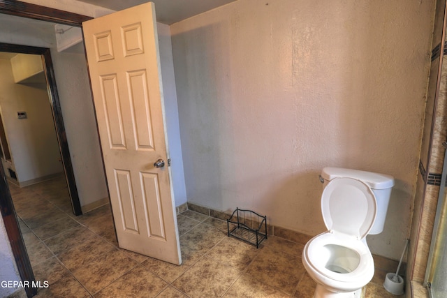 bathroom with toilet and tile patterned floors