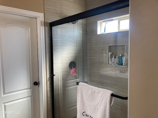 bathroom with a shower with shower door