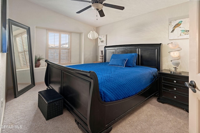 bedroom with light carpet, lofted ceiling, and ceiling fan