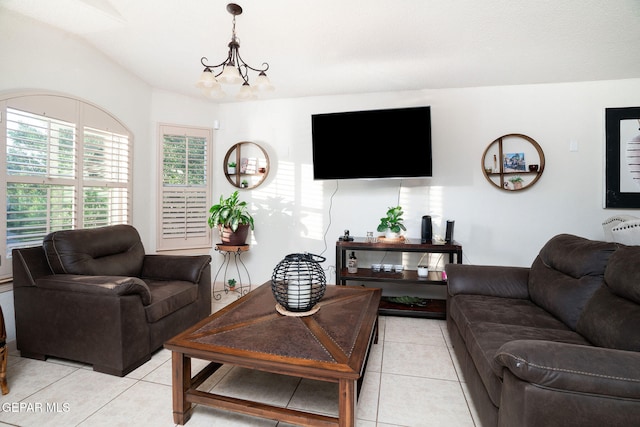 tiled living room featuring a chandelier