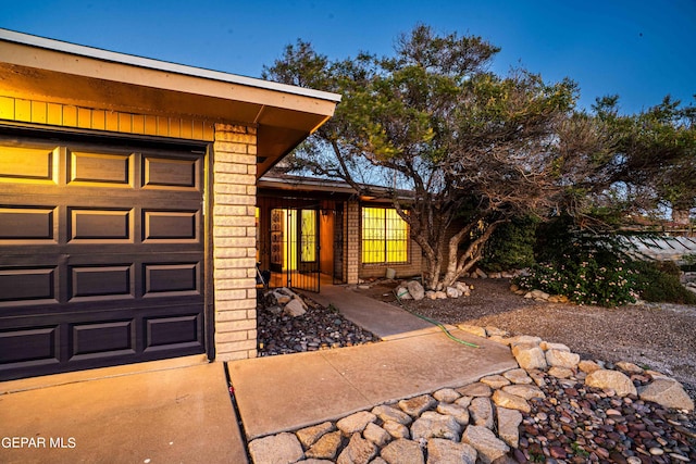 view of exterior entry with a garage