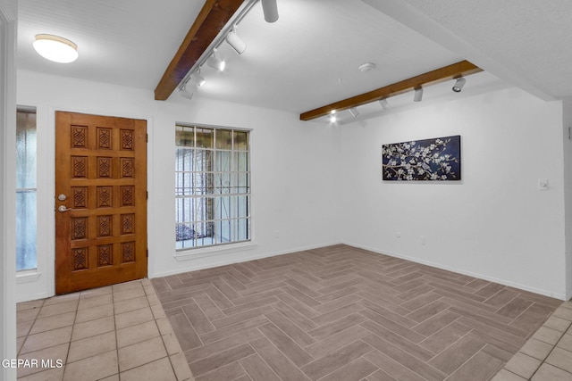 foyer featuring light tile patterned flooring, beamed ceiling, and rail lighting