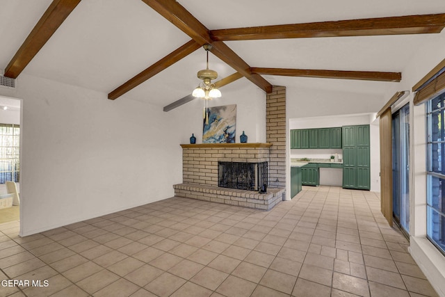 unfurnished living room featuring lofted ceiling with beams, ceiling fan, a fireplace, and light tile patterned floors