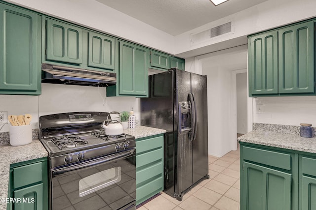 kitchen with decorative backsplash, a textured ceiling, light tile patterned flooring, black appliances, and green cabinets