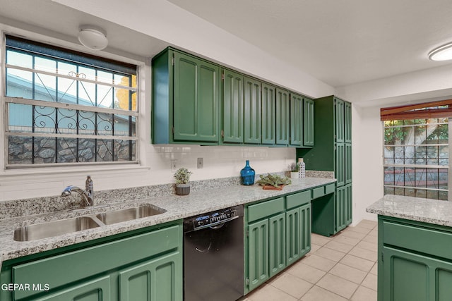 kitchen with black dishwasher, sink, green cabinets, decorative backsplash, and light tile patterned floors