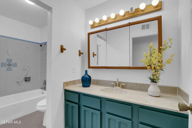 full bathroom featuring vanity, toilet, tiled shower / bath combo, and tile patterned flooring