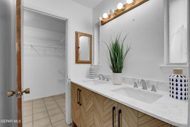 bathroom featuring vanity, a textured ceiling, and tile patterned floors