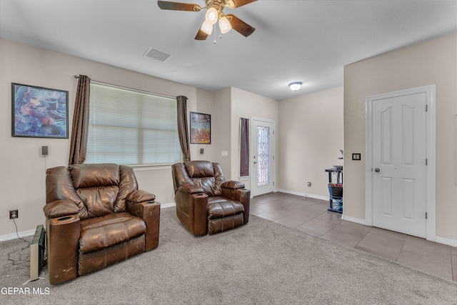 sitting room featuring tile patterned floors and ceiling fan