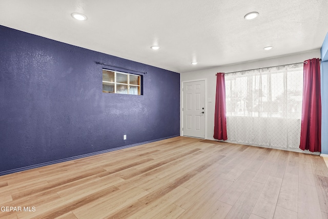 spare room featuring light hardwood / wood-style flooring