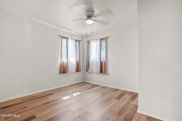 empty room featuring light hardwood / wood-style flooring and ceiling fan