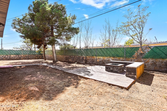 view of yard with a patio area and a fire pit