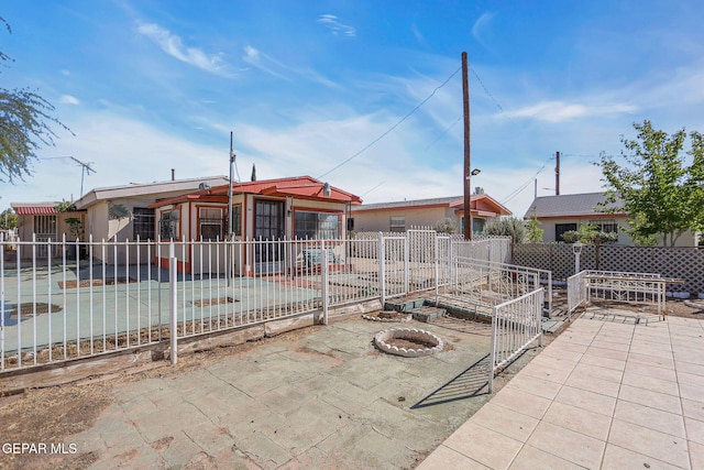 view of front of home with a patio and an outdoor fire pit