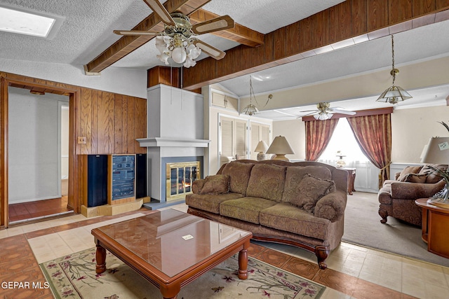 living room with a fireplace, lofted ceiling with beams, a textured ceiling, ceiling fan, and light tile patterned floors