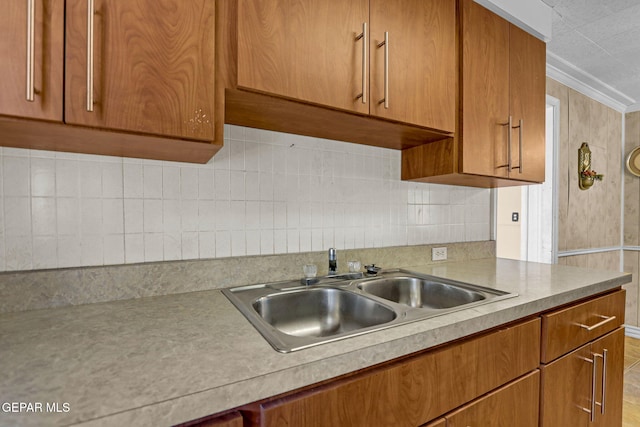 kitchen with crown molding and sink