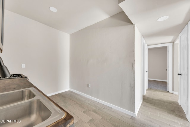 kitchen with sink and light hardwood / wood-style flooring